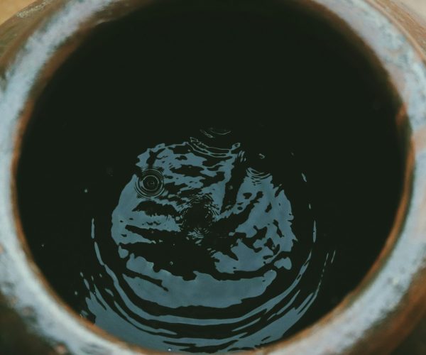 liquid inside brown clay jar